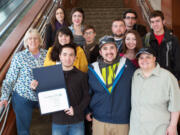 Central Park: Kyle Yasumiishi, editor-in-chief of Clark College's student newspaper the Independent, holds an award he and his staff, pictured, brought back from a journalism conference in San Francisco early this month.