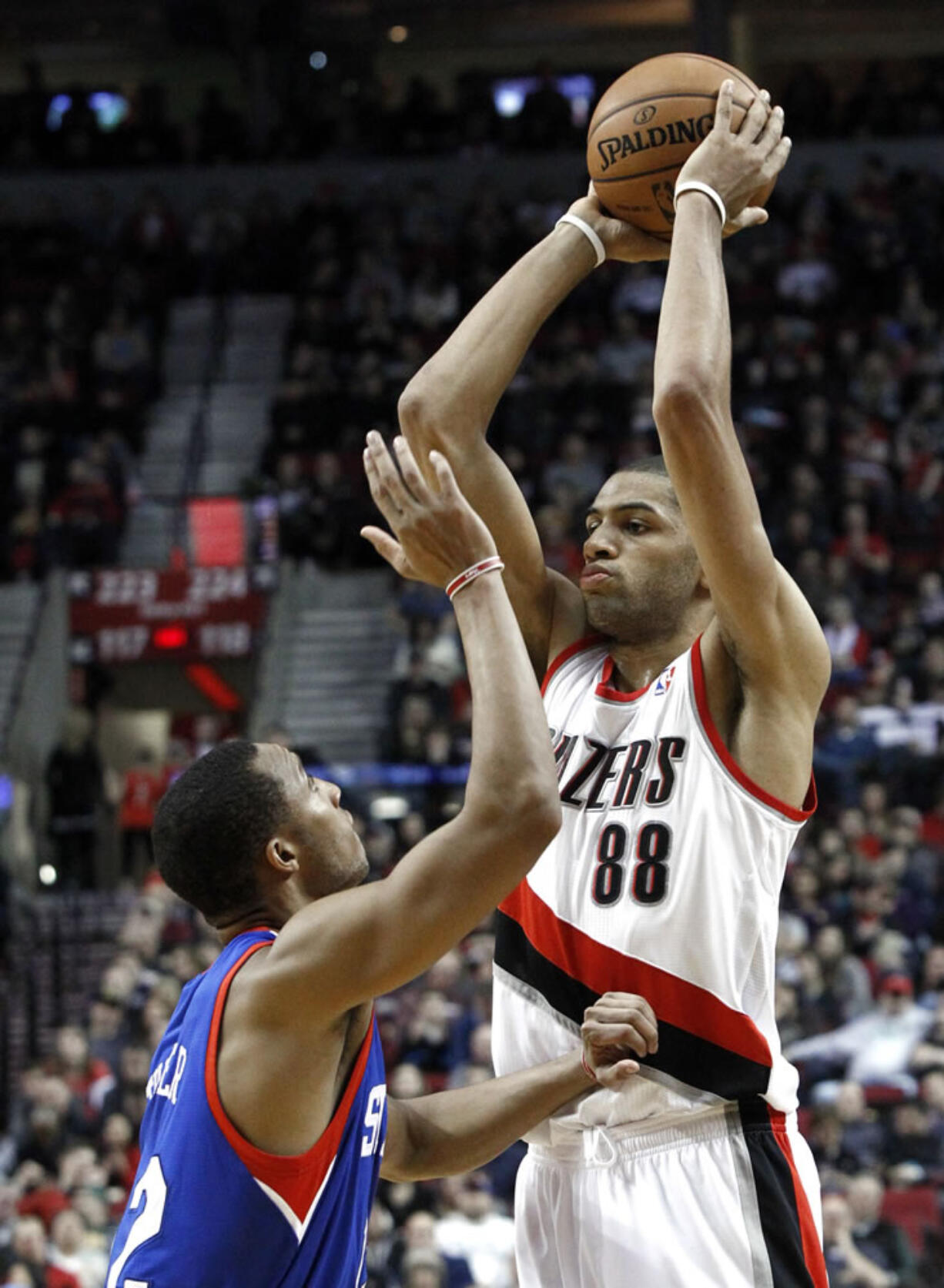 Portland Trail Blazers forward Nicolas Batum (88) looks to pass inside against Philadelphia's Evan Turner.