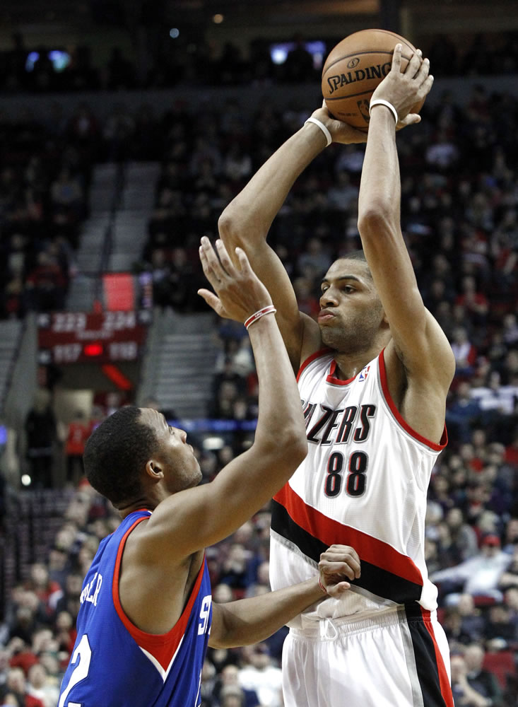 Portland Trail Blazers forward Nicolas Batum (88) looks to pass inside against Philadelphia's Evan Turner.