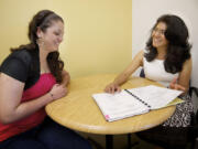 Rosalba Pitkin, right, counsels Julie Mercado, a second-year student at Clark College. Pitkin is an Aztec-Mexican who immigrated to the United States and has played a pivotal role on the State Commission on Hispanic Affairs. In her day job, she helps international students at Clark College adjust to the U.S.