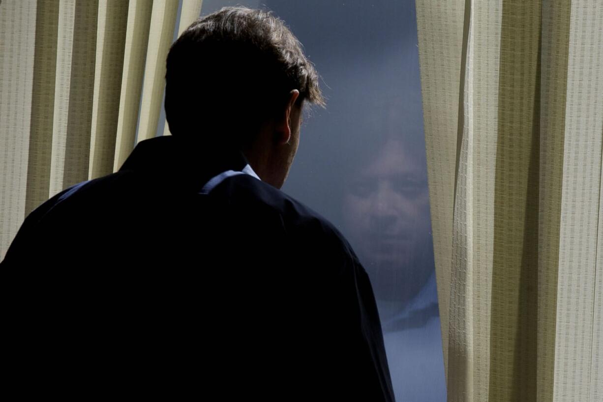 Dennis Wolter, accused of killing his estranged  girlfriend in May 2011, looks out the window today during a morning recess of his trial in Clark County Superior Court Judge Robert Lewis' courtroom.