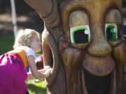 Natalie Oneil, 7, of Vancouver, looks inside an empty tree costume at the Old Apple Tree Festival on Saturday.