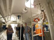 Justin Piper, right, a BNSF hazmat manager, provides training to firefighters and other safety personnel inside a tank car designed for training purposes Tuesday in Vancouver.