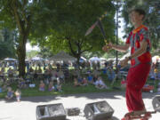 Rhys Thomas juggles knives while standing on swords.