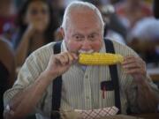 Bud Webster, 79, of La Center bites in to a cob of corn Saturday at the Sausage Fest at St. Joseph Catholic School.