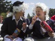 Emalee Weaver, left, draws a laugh from Camryn Jurcich during Flag Day at Fort Vancouver. Weaver, dressed as Robert Livingston, and Jurcich, portraying John Adams, helped give a history lesson on the flag during Friday's festivities.