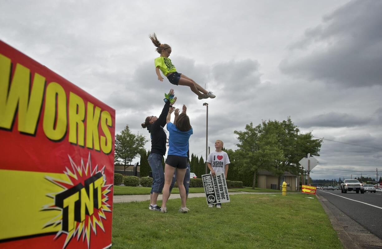 Maleigha Williams, 8, comes down for a basket catch from Katy Griffee, 15, center, and Jennifer Foster, left, with observer Connor Foster, 9, right, on Sunday.