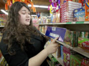 Hudson's Bay High School DECA club President Maria Melchor, 18, talks on Wednesday about how she used math to figure out nutritional values of products at Mercado Latino in Vancouver.