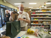 David Page, aka member No. 35, checks out at the Vancouver Food Cooperative Friday afternoon.