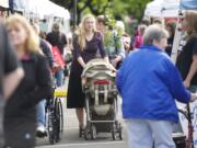 Jennifer Burian pushes her 7-day-old baby, Lara, in a stroller as she shops at the Camas Farmer's Market on Wednesday.