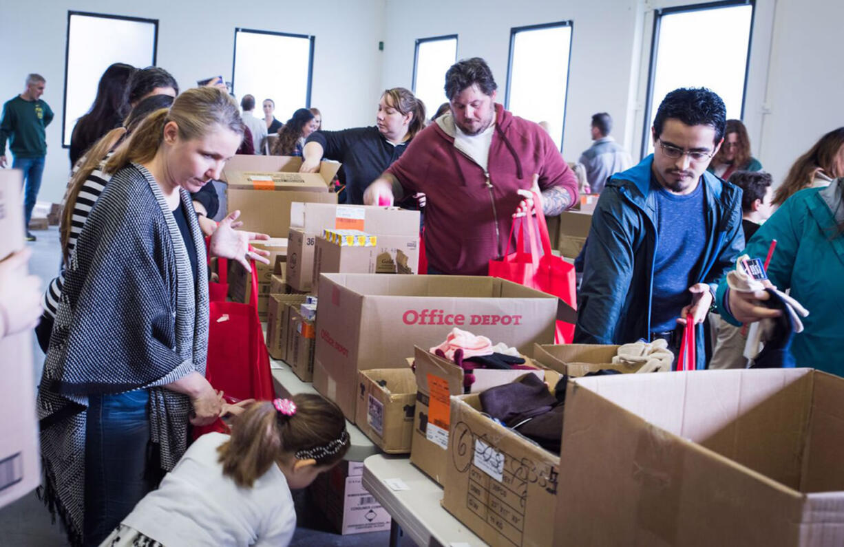 Orchards: Volunteers packing up holiday bags containing daily essential items, such as soap and toothpaste, to donate to Share.