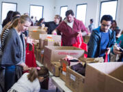 Orchards: Volunteers packing up holiday bags containing daily essential items, such as soap and toothpaste, to donate to Share.