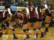 Prairie players celebrate the winning point in game two of their 3A volleyball state championship against North Thurston.