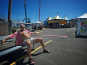 Vancouver native Dennis Kostman, 64, soaks up the sun at the Clark County Fair on Saturday. Kostman says he enjoys the heat.