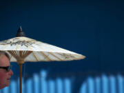 Clara Chambers walks with a parasol on Saturday while trying to keep the sun off of her at the Clark County Fair.