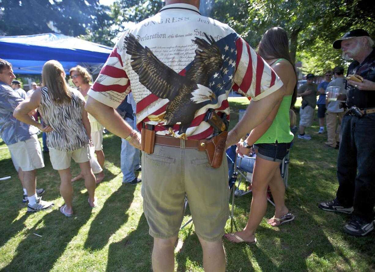 Vancouver resident Tracy Wilson, 53, joins others at a picnic Saturday at Esther Short Park organized by OpenCarry.org Washington.