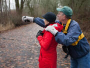 Arden Hagen, right, points out birds at Vancouver Lake Park to Jan Verrinder while participating in the annual Christmas Bird Count on Sunday.