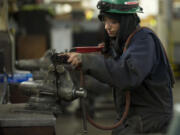 Bree Smith repairs welding equipment at Gunderson in Portland.