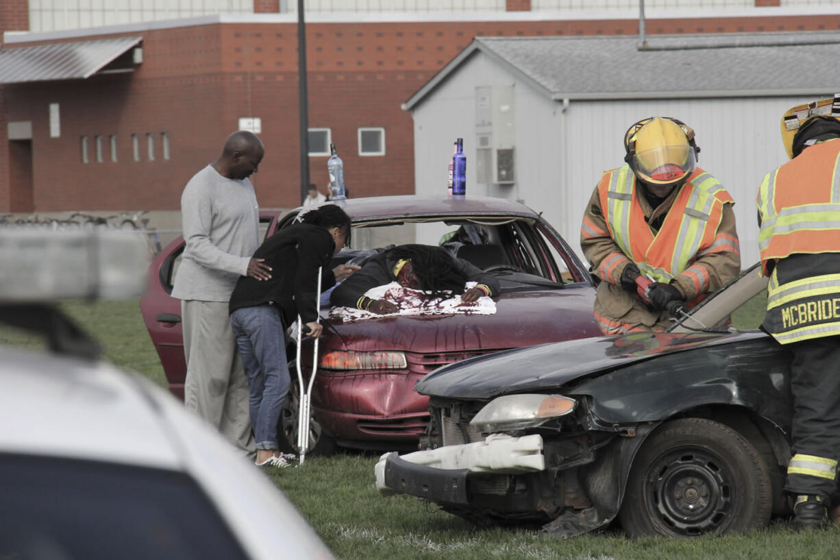 Orchards: Heritage High School senior E'Lon Mack pretends to have died in a drunken driving-related crash while his parents Sheila and Willie, participate in the mock event Sept.