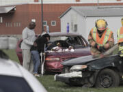 Orchards: Heritage High School senior E'Lon Mack pretends to have died in a drunken driving-related crash while his parents Sheila and Willie, participate in the mock event Sept.