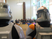 Camas: Members of Oregon and Southwest Washington's Cloud City Garrison, a chapter of the 501st Legion of Stormtroopers Star Wars Imperial costuming club, watch a performance by the Liberty Middle School Jazz Choir May 11 at the Camas Public Library 90th anniversary celebration.