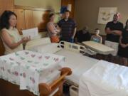 Raquel DeWitt with Kaiser Permanente, left, leads a tour through Legacy Salmon Creek Medical Center's Family Birth Center for a group of expectant parents, including from second left, Cherise and Corey Marshall, Mike and Zaneta Kaplan and Troy and Kaylyn Smith. Beginning Oct.