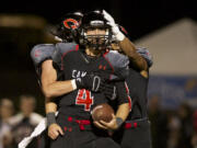 Camas quarterback Reilly Hennessey celebrates after scoring against Union at Doc Harris Stadium.