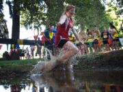 Fort Vancouver junior Carlie Latimer crosses the water hazard during the Run-A-Ree at Hudson's Bay on Friday.