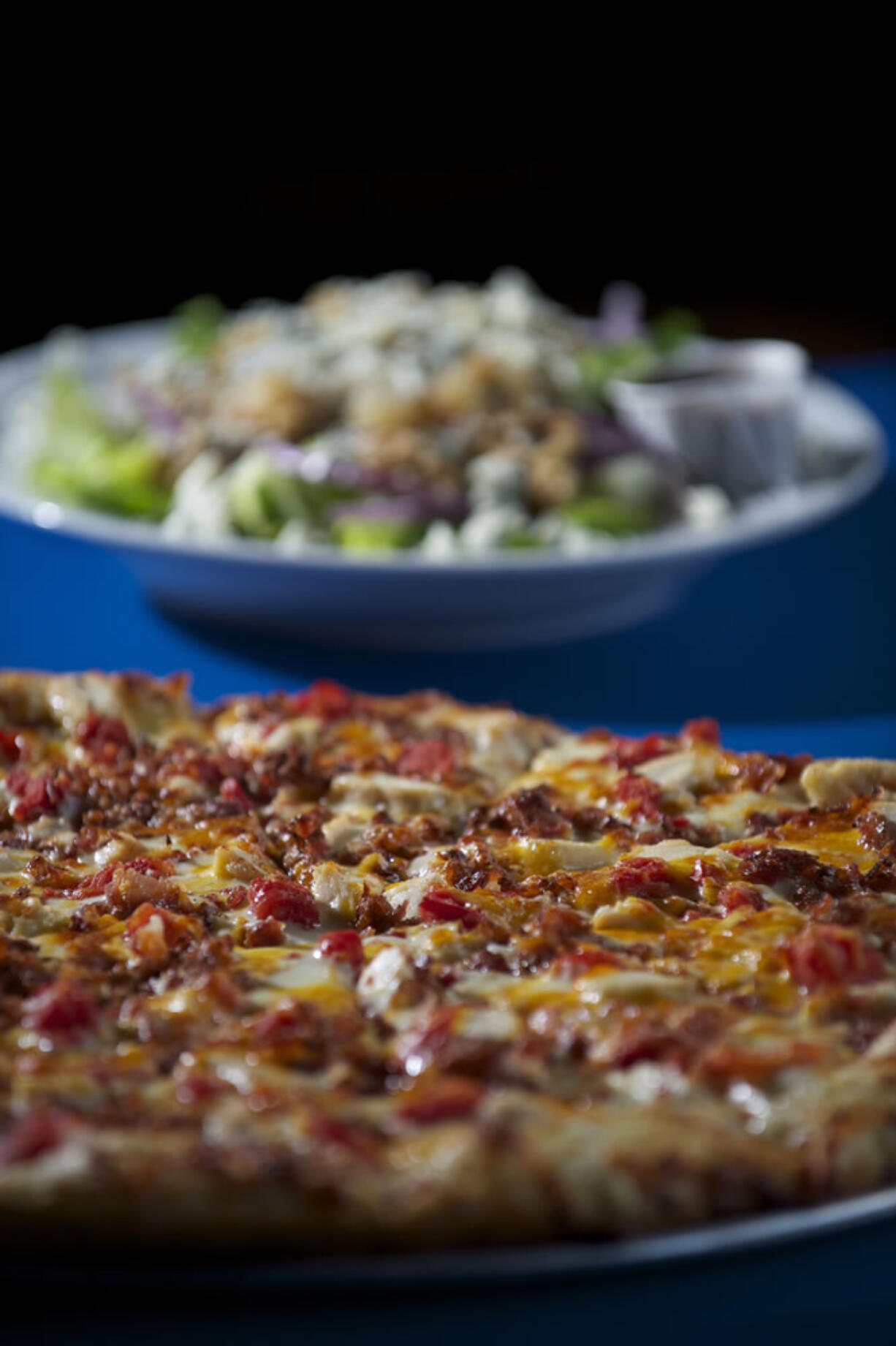 The Primavera pizza and the Pear and Gorgonzola Salad at Bortolami's Pizzeria, which offers traditional and specialty pizzas as well as calzones, strombolli, sub sandwiches, salads, and a few dessert items.