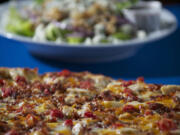 The Primavera pizza and the Pear and Gorgonzola Salad at Bortolami's Pizzeria, which offers traditional and specialty pizzas as well as calzones, strombolli, sub sandwiches, salads, and a few dessert items.