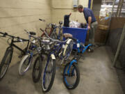 C-Tran spokesman Scott Patterson looks over found items at the agency's headquarters off of Fourth Plain Boulevard. In the summer, about six bikes a month are left on the front of buses by passengers.