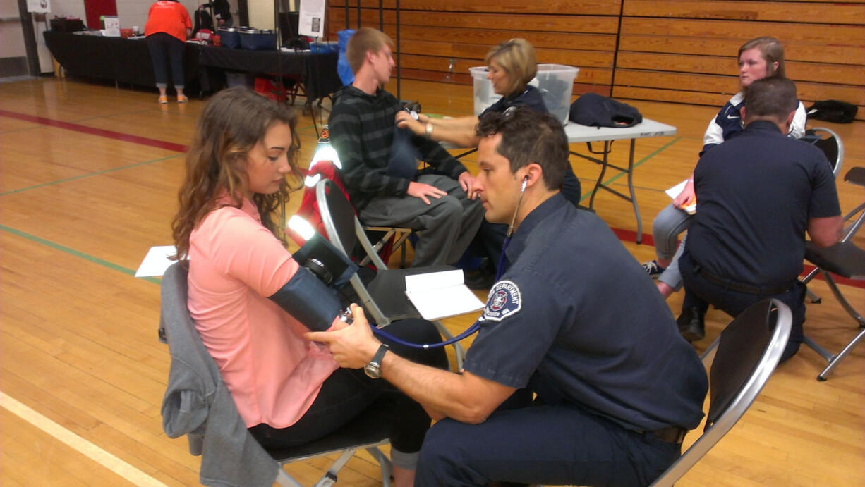 Meadow Homes: Fort Vancouver High School student Ivana Angel gets her blood pressure checked by Darrin Deming of the Vancouver Fire Department during the May 22 &quot;Heart Your Health: Stay Strong Live Long&quot; event, coordinated by The Hope Heart Institute.