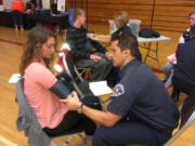 Meadow Homes: Fort Vancouver High School student Ivana Angel gets her blood pressure checked by Darrin Deming of the Vancouver Fire Department during the May 22 &quot;Heart Your Health: Stay Strong Live Long&quot; event, coordinated by The Hope Heart Institute.