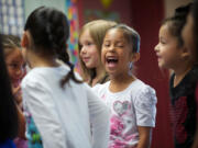 Kindergartner Ashly Prado Virelas, center, is one of about 500 students in Vancouver who went to school a few weeks early under the Jump Start program last summer.