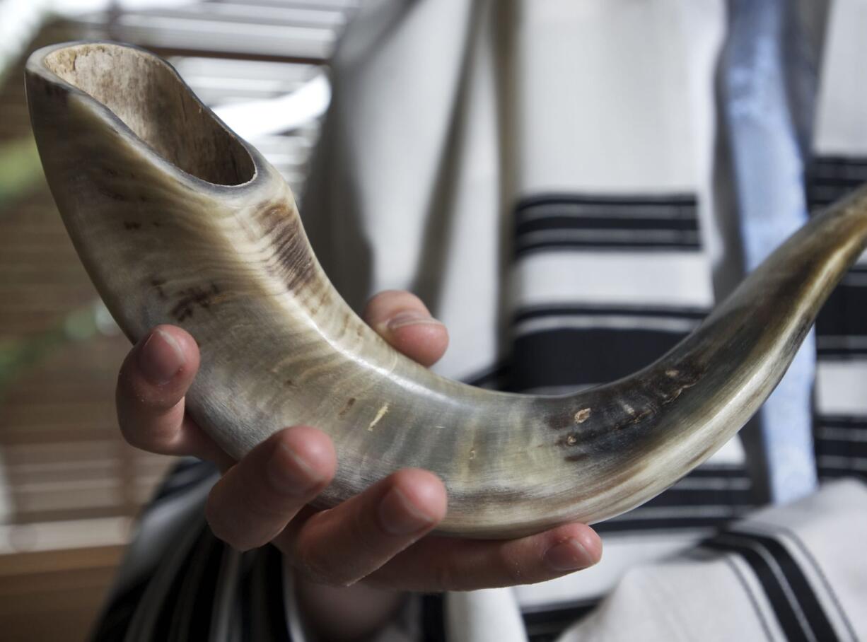 Rabbi Shumlik Greenberg of Chabad Jewish Center displays the ram's horn, or shofar, that he uses to proclaim the Jewish New Year.