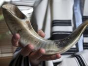 Rabbi Shumlik Greenberg of Chabad Jewish Center displays the ram's horn, or shofar, that he uses to proclaim the Jewish New Year.