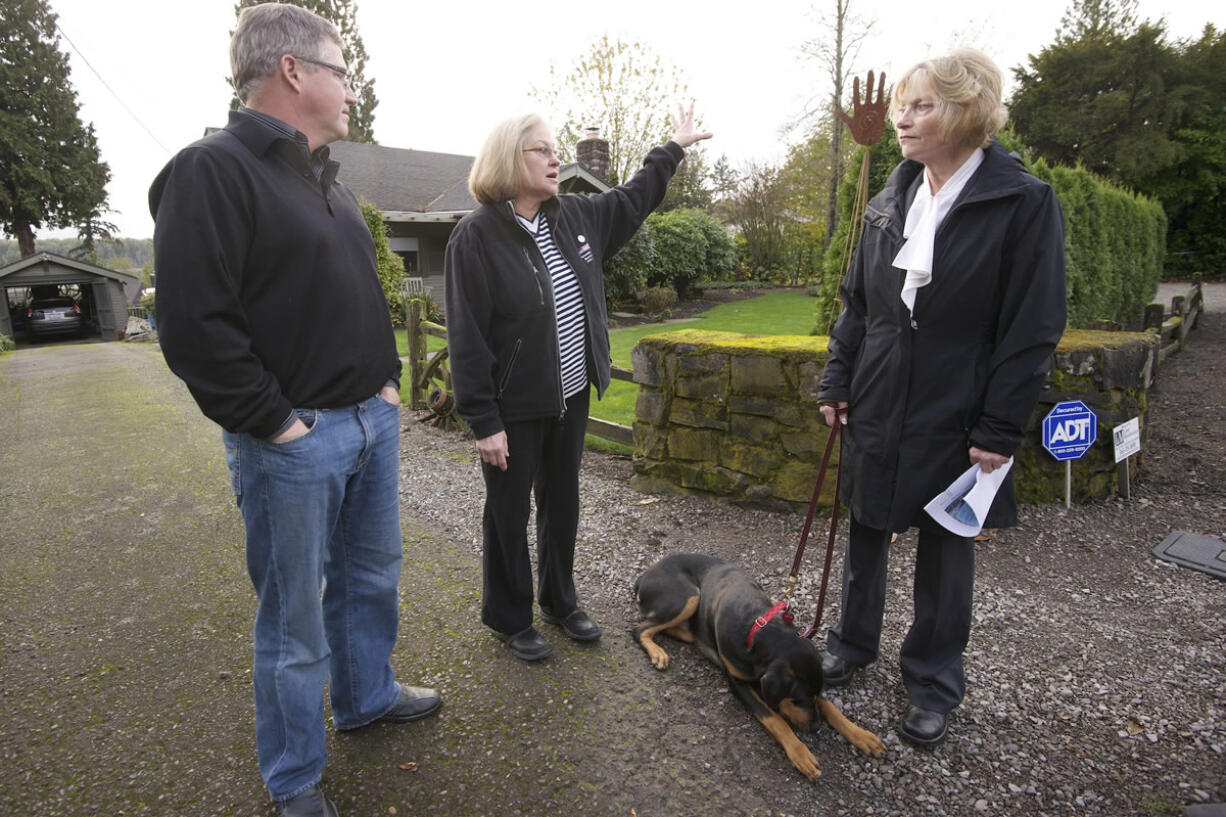 Evergreen Highway neighbors Chris Kellogg, from left, Jean Cox and Dode Jackson talk about safety concerns in their neighborhood.