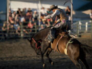 Photos by Zachary Kaufman/The Columbian
Trent Ezell, 19, of Emerson, Ore., gets his turn in the saddle bronc riding Saturday night at the Vancouver Rodeo. About 460 contestants competed over the rodeo's four-day run.