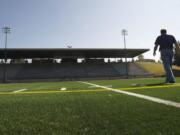 Patrick O'Day, construction project manager for Evergreen Public Schools, shows off the new turf that is being installed at McKenzie Stadium.