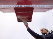 Sandy Wozny of Vancouver places her ballot in a drop box near the Clark County Elections Department prior to last year's general election.