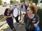 Shannon A. Walker, president of the Southwest Washington Central Labor Council, leads a group of Service Employees International Union Local 49 supporters during a rally at PeaceHealth St. John Medical Center in Longview. The union, which represents 460 hospital workers at St.