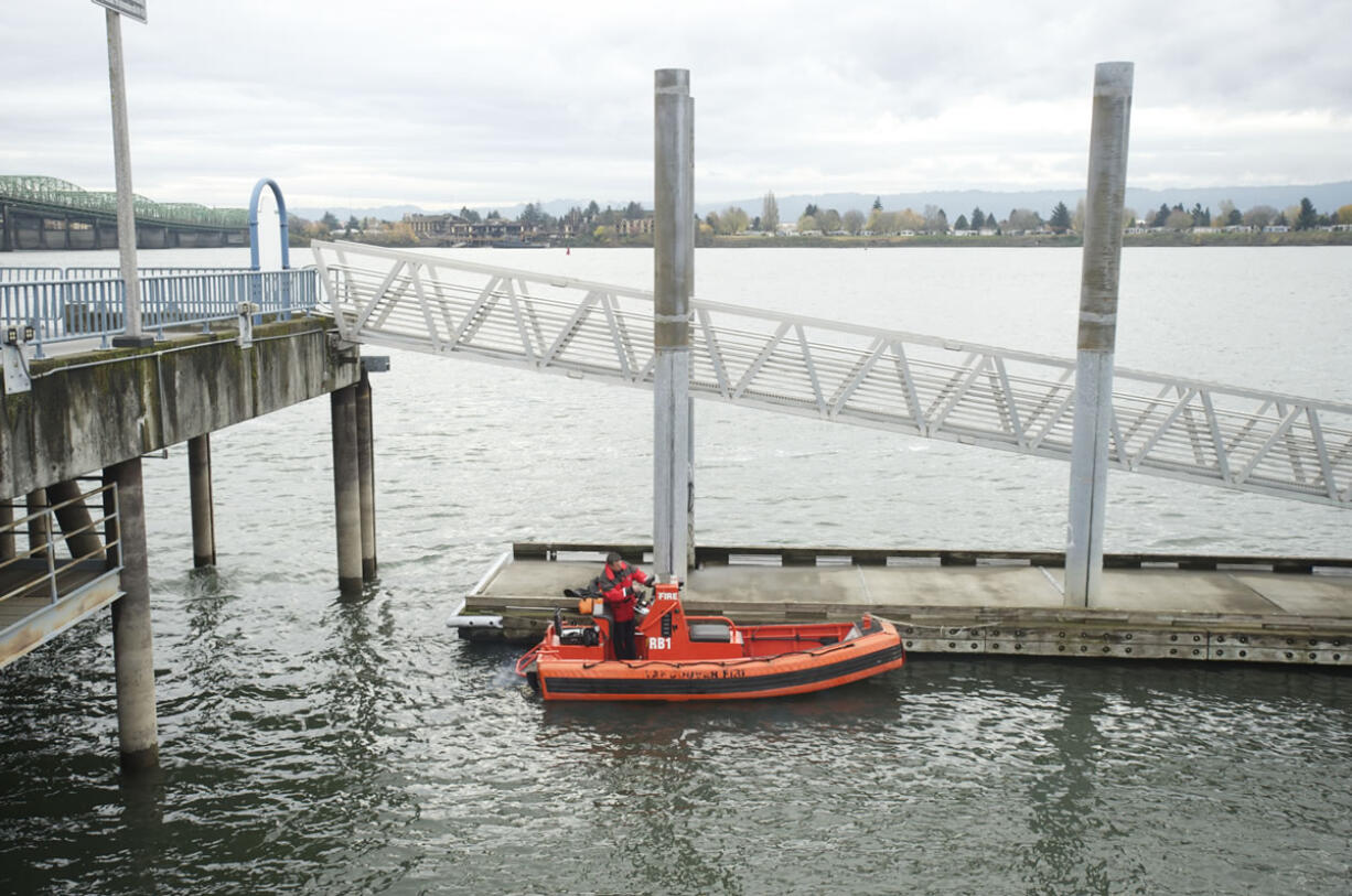 Vancouver firefighter Casey Holmes preps the department's boat, which was bought for $500 five years ago, for a media ride on the Columbia River on Nov.