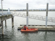 Vancouver firefighter Casey Holmes preps the department's boat, which was bought for $500 five years ago, for a media ride on the Columbia River on Nov.