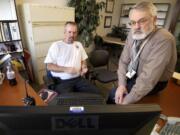 Clark County Risk Manager Mark Wilsdon, right, with Bob Moag, a facility maintenance specialist, track county vehicles via GPS Insight from Wilsdon's office at the Clark County Public Service Center in Vancouver.