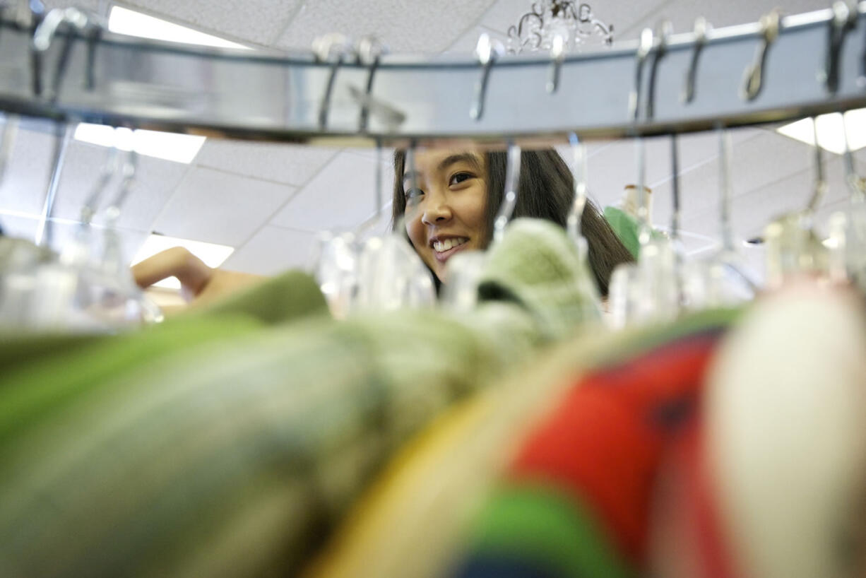 Skills Center student Julianne Cubacub, 17, sorts clothing at Deja Vu Consignment  on Tuesday.