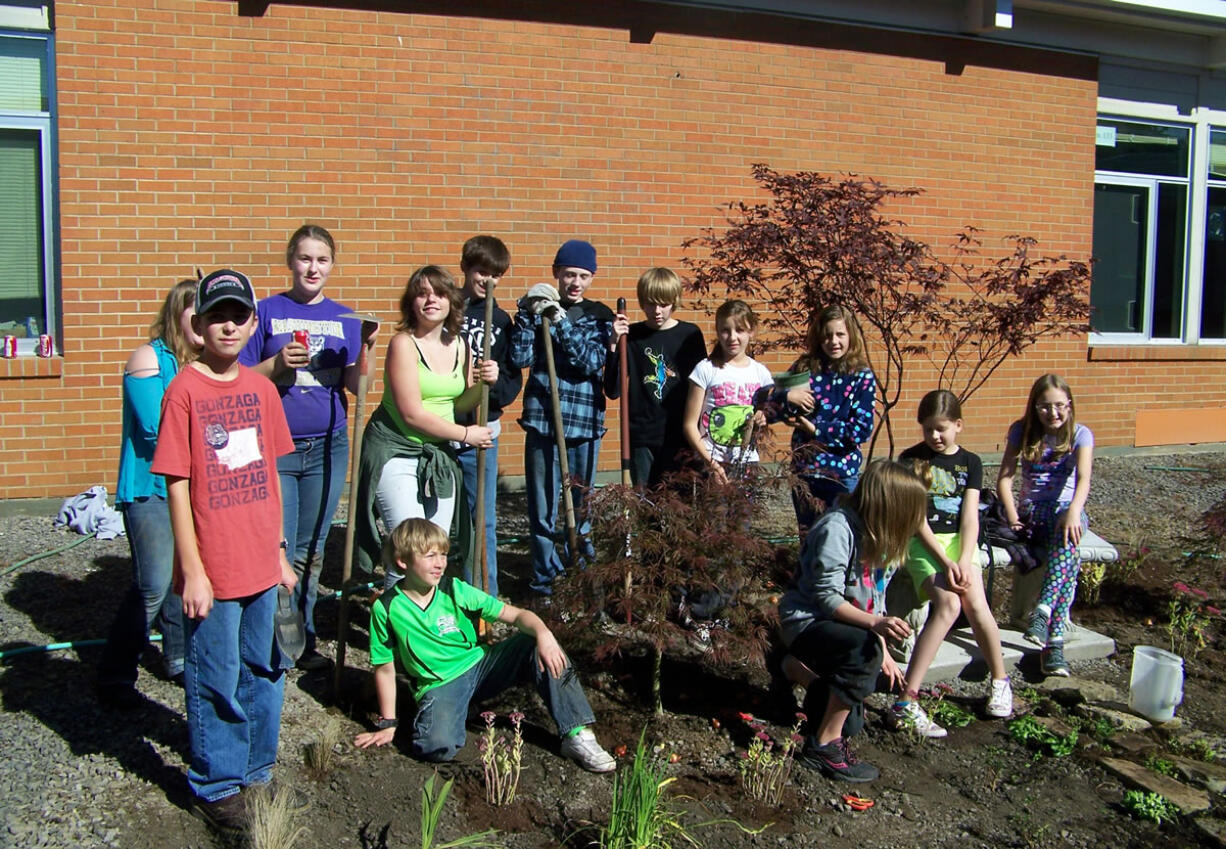 La Center: Youths in the La Center Lions' Leading LEO Club help plant a garden Oct.