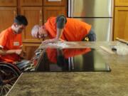 Central Park Place: Employees with &quot;Team Depot&quot; install new countertops at the apartment building for homeless veterans and others.