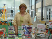 Fircrest: Altrusa International of Clark County President Tina Smith stands by more than 100 books that were given to local children Sept.