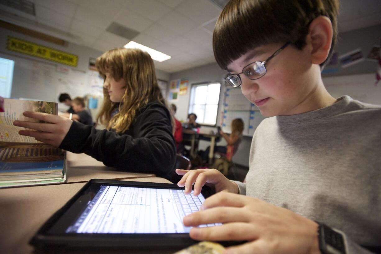 Trevor Bryant uses an iPad in Monica Hughey's sixth grade class at McLoughlin Middle School, one of the Vancouver district schools piloting the iPad program.