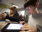 Trevor Bryant uses an iPad in Monica Hughey's sixth grade class at McLoughlin Middle School, one of the Vancouver district schools piloting the iPad program.